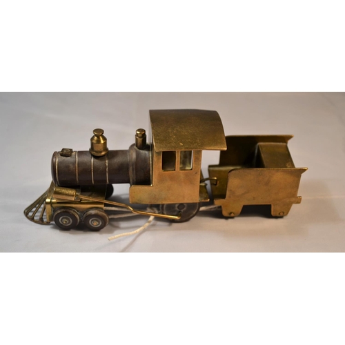 425 - A rare and unusual early 20th century brass and Bakelite model train with carriage. Probably WW2 per... 