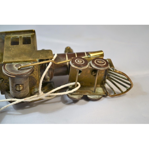 425 - A rare and unusual early 20th century brass and Bakelite model train with carriage. Probably WW2 per... 