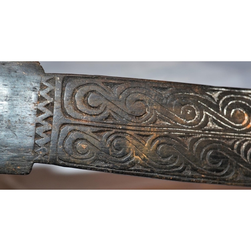 402 - An unusual antique carved wooden tool possibly Maori or South Sea Islands. The handle carved with wa... 