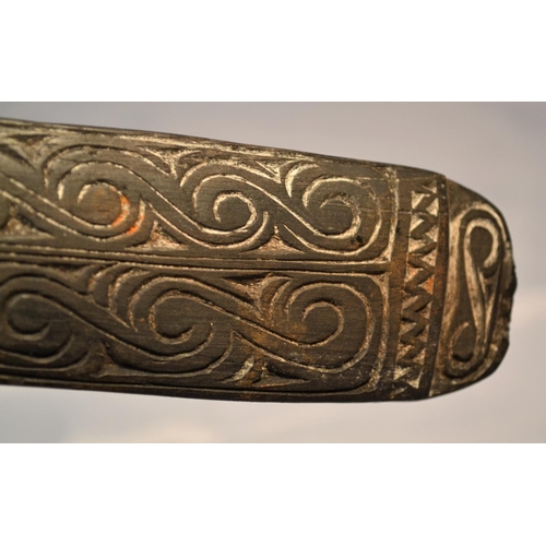 402 - An unusual antique carved wooden tool possibly Maori or South Sea Islands. The handle carved with wa... 