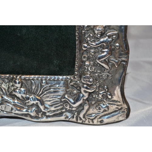 359 - A silver photograph frame decorated with cherubs - Birmingham 1997 by Ray Hall - approx 9