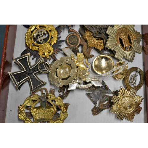 102 - A quantity of military badges to include a WW1 iron cross