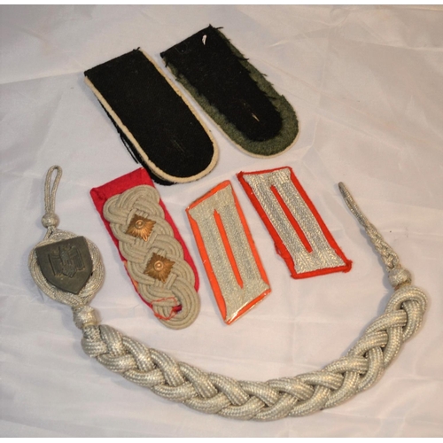 105 - A bag of German military patches to include an aiguillette