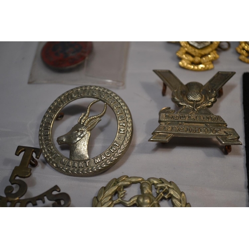 106 - A quantity of British military badges and a patch