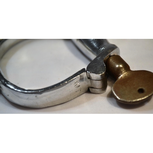 110 - A pair of vintage Hiatt hand cuffs with key