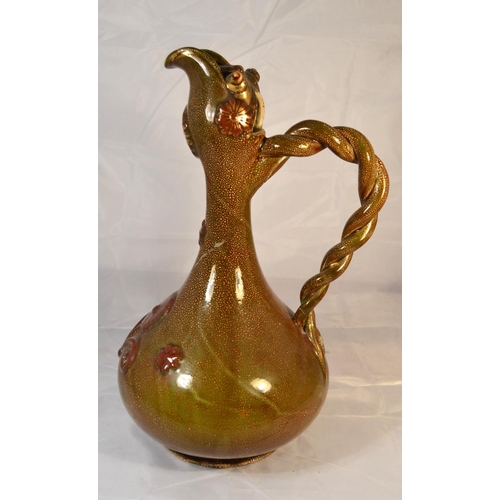 420 - An unusual grotesque pottery ewer with antique paper labels on the base. Approx 14