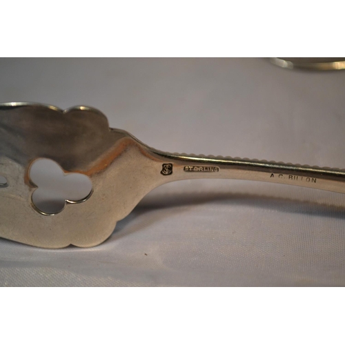 443 - 2 pieces of foreign silver - a American silver bread fork and an unusual white metal butter knife