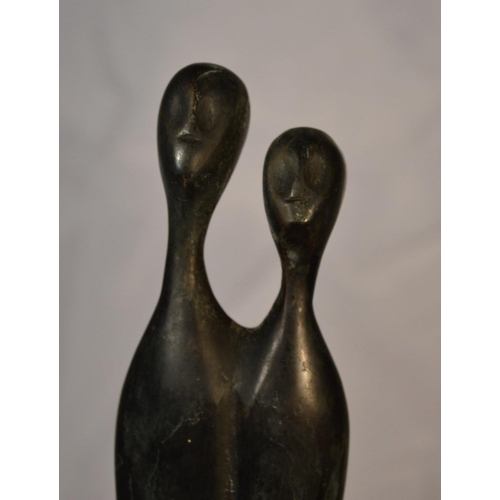 530 - A bronze sculpture of 2 tall thin figures impressed verso 