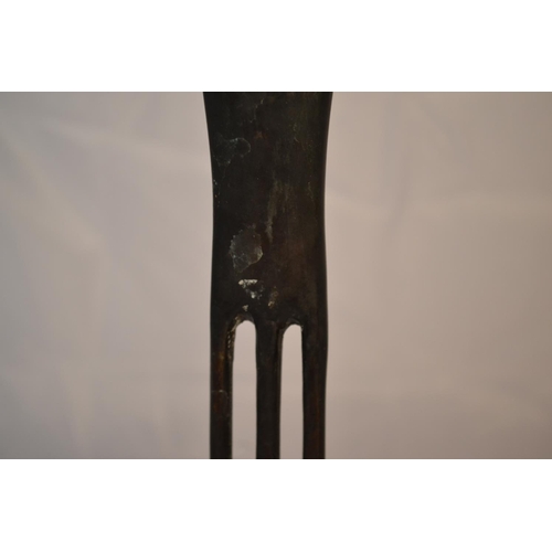 530 - A bronze sculpture of 2 tall thin figures impressed verso 