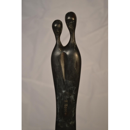 530 - A bronze sculpture of 2 tall thin figures impressed verso 