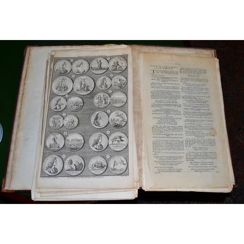 257 - A 17th century leather book cover from a book on Cambridge University and containing pages of medals... 