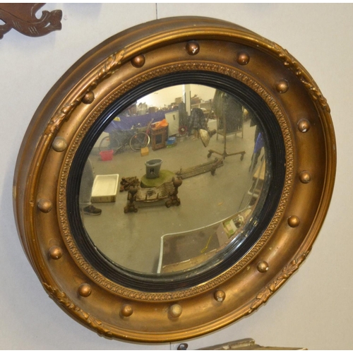 504 - An antique gilt convex wall mirror - 18