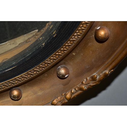 504 - An antique gilt convex wall mirror - 18