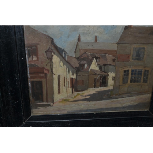 557 - An unusual small black framed oil on board of a street scene c.1930 - unsigned but pencil inscriptio... 