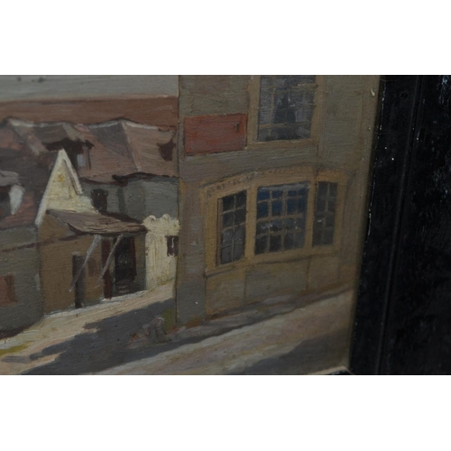 557 - An unusual small black framed oil on board of a street scene c.1930 - unsigned but pencil inscriptio... 