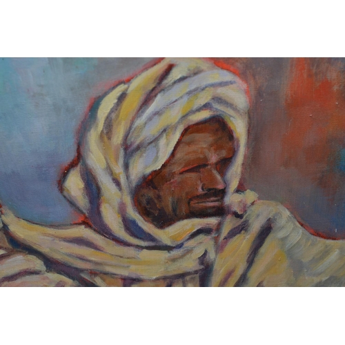 559 - J Hay (20thC) - An oil on canvas of a seated Arabic gentleman with Arabic script signed J Hay lower ... 