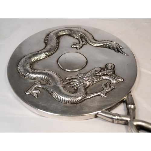 450 - An early 20th century Chinese export silver hand mirror decorated with a dragon and bamboo - approx ... 