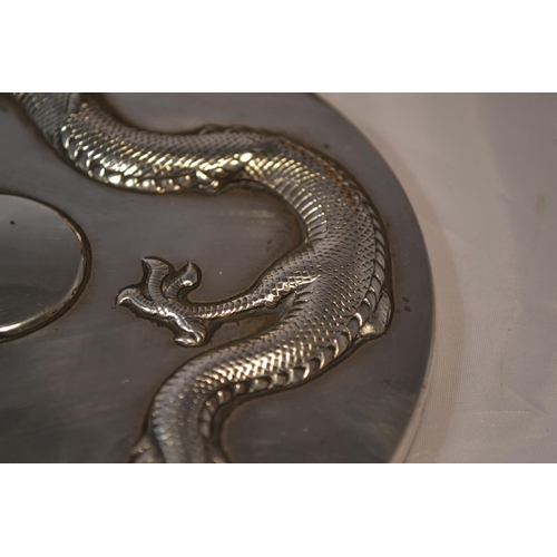 450 - An early 20th century Chinese export silver hand mirror decorated with a dragon and bamboo - approx ... 