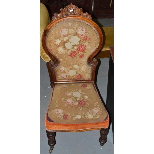 71 - A Victorian carved and upholstered bedroom chair on casters