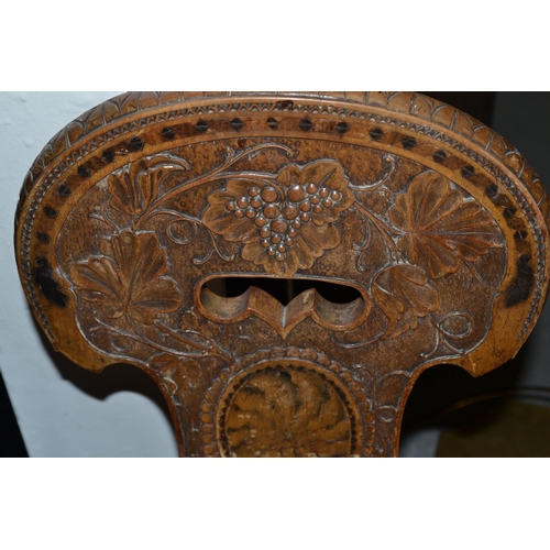 73 - A 19th century hall chair carved with Bacchanalian motifs.