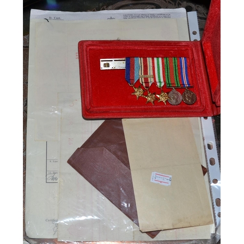 127 - A collection of military ephemera to include miniature medals