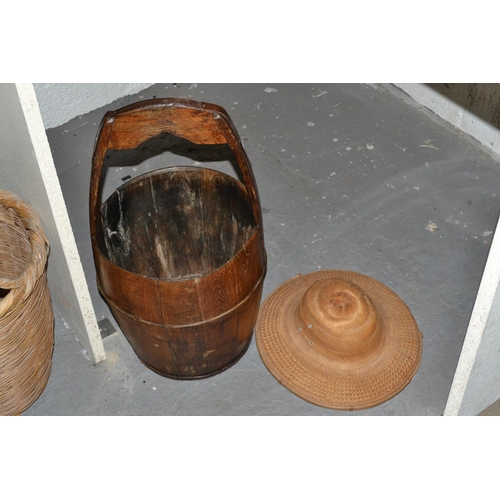 169 - An oriental wooden rice bucket and a straw hat