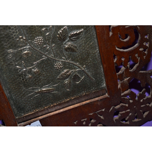 172 - An early 20th century Arts and Crafts beaten metal panel set into a fretwork frame