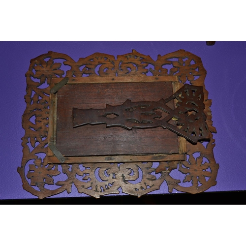 172 - An early 20th century Arts and Crafts beaten metal panel set into a fretwork frame