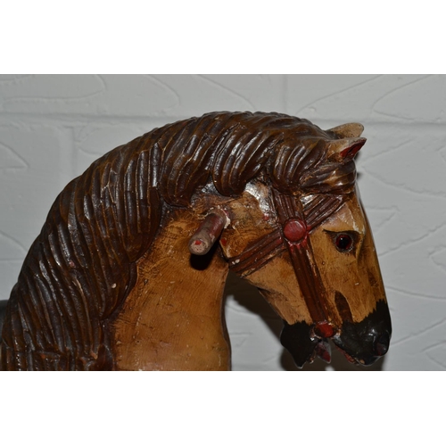 174 - A carved wooden rocking horse