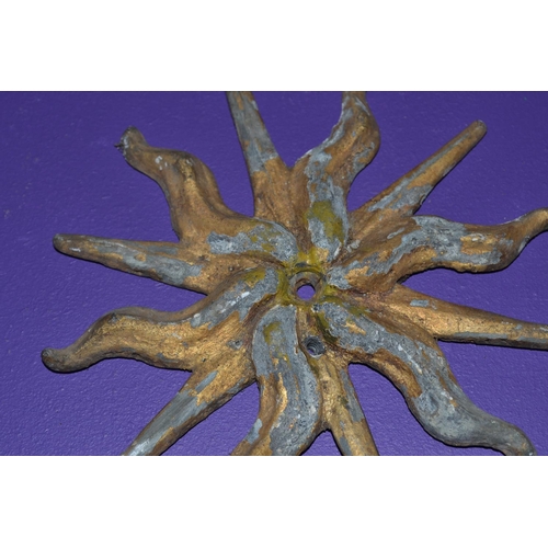 201 - A pair of 19th century or earlier cast lead painted sunburst symbols -