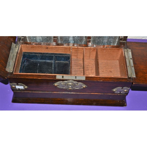 204 - A late 19th century 3 bottle games Tantalus with secret drawer