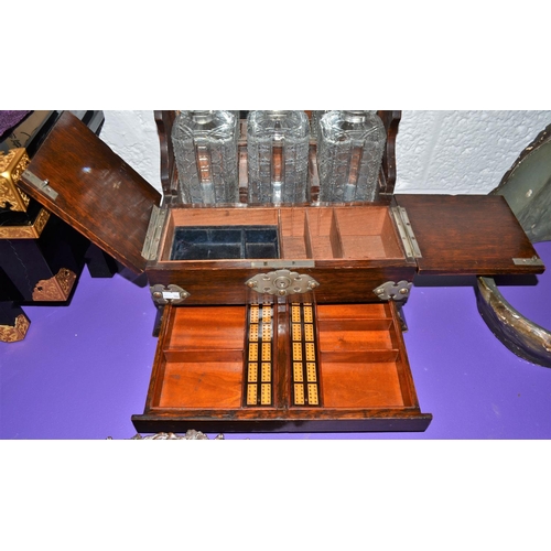 204 - A late 19th century 3 bottle games Tantalus with secret drawer