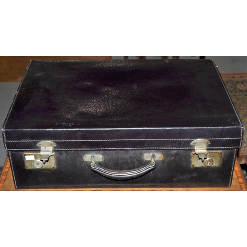 236 - A vintage black leather travelling suitcase and contents