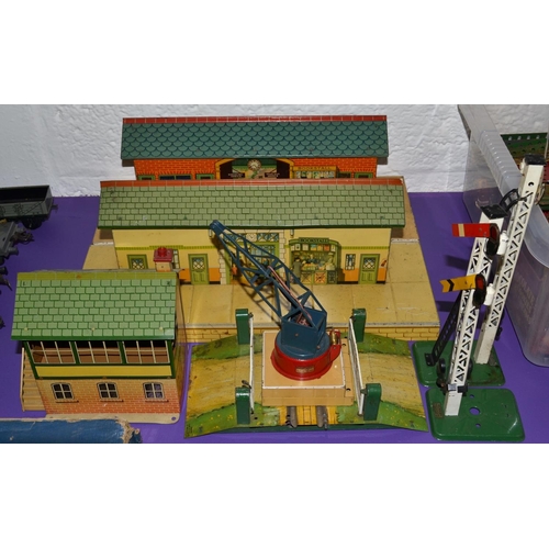 271 - A quantity of vintage Hornby tin plate buildings, a crane and 2 signals