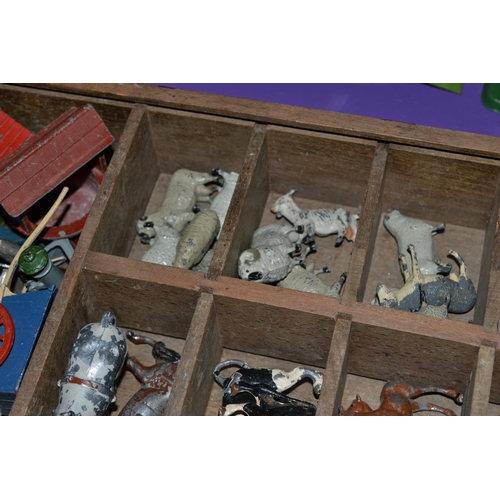 272 - A box of cast lead farm animals and farm machinery - some Britains