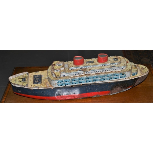 277 - A vintage tin plate boat or cruise ship originally housing a motor