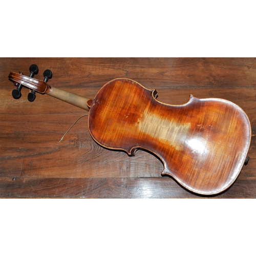 284 - An antique violin with a one piece back bearing a Stradivarius label - case and bow