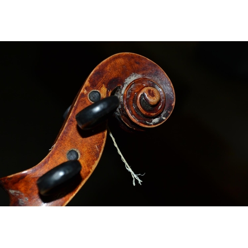 284 - An antique violin with a one piece back bearing a Stradivarius label - case and bow