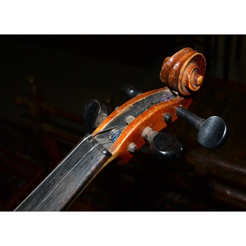 285 - An antique violin with a 2 piece back bearing a Stradivarius label - case and bow