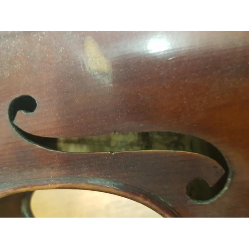 284 - An antique violin with a one piece back bearing a Stradivarius label - case and bow