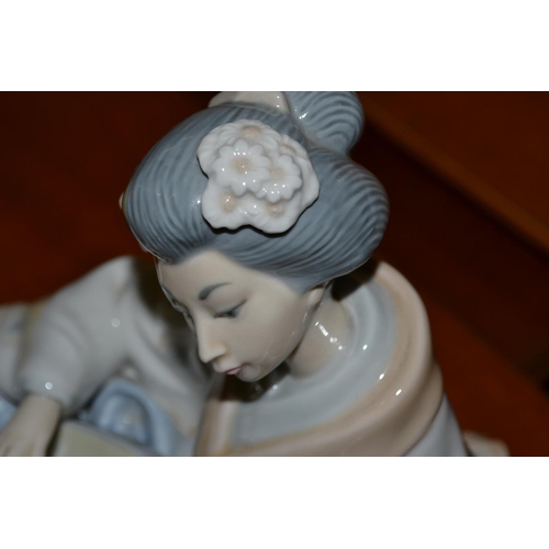 379 - A Nao figure of an Oriental lady playing a Shamisen