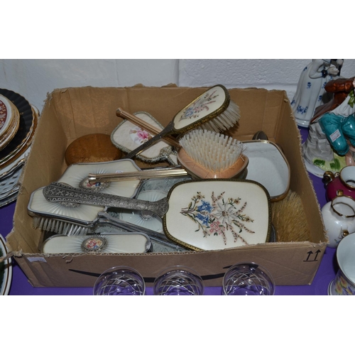 451 - A quantity of vintage dressing table sets, mirrors and brushes