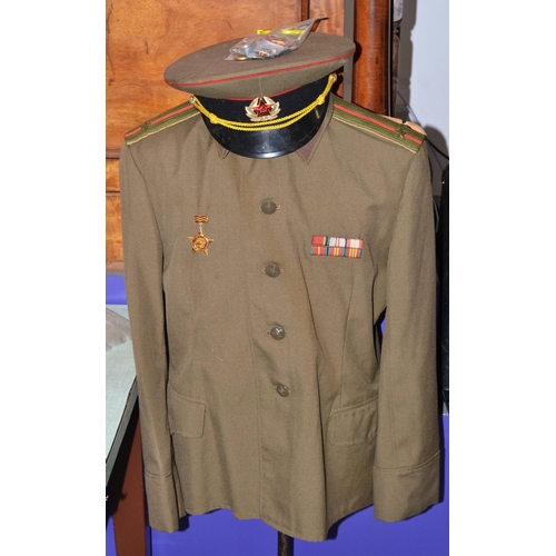 521 - A Russian Artillery officers uniform (tunic, cap and trousers) with medals