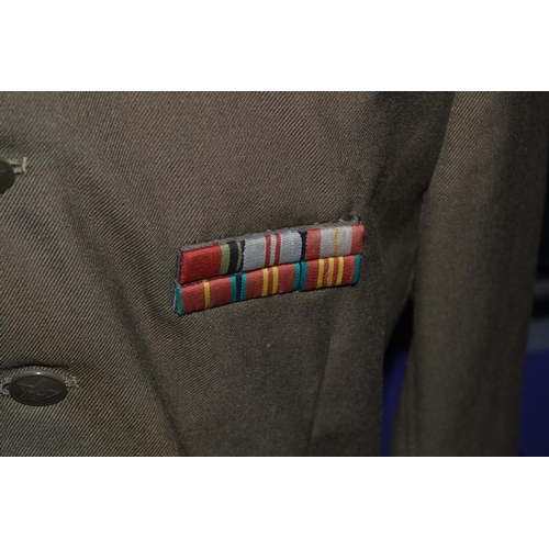 521 - A Russian Artillery officers uniform (tunic, cap and trousers) with medals