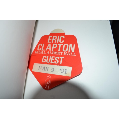 534 - A quantity of Eric Clapton memorabilia to include a signed book and some other signed items