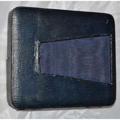 598 - Hand coloured miniature photograph in a leather folding case