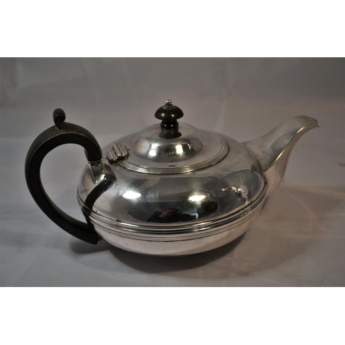 696 - A solid silver teapot - London 1899 by Carrington & Co - 722g gross