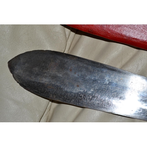 742 - A vintage Klweang tear drop shaped machete in red leather scabbard