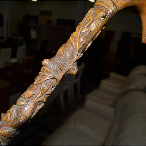 746 - A vintage folk art carved walking stick with Oak and acorn design