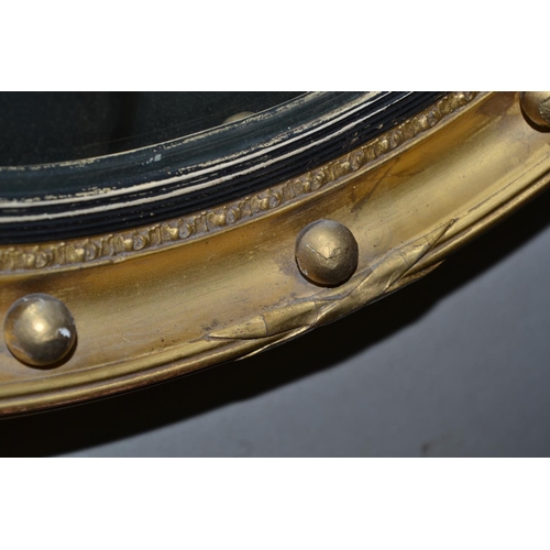 228 - An early 20th century gilt framed convex wall mirror